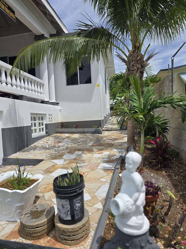 Manicured garden path leading to the villa entrance